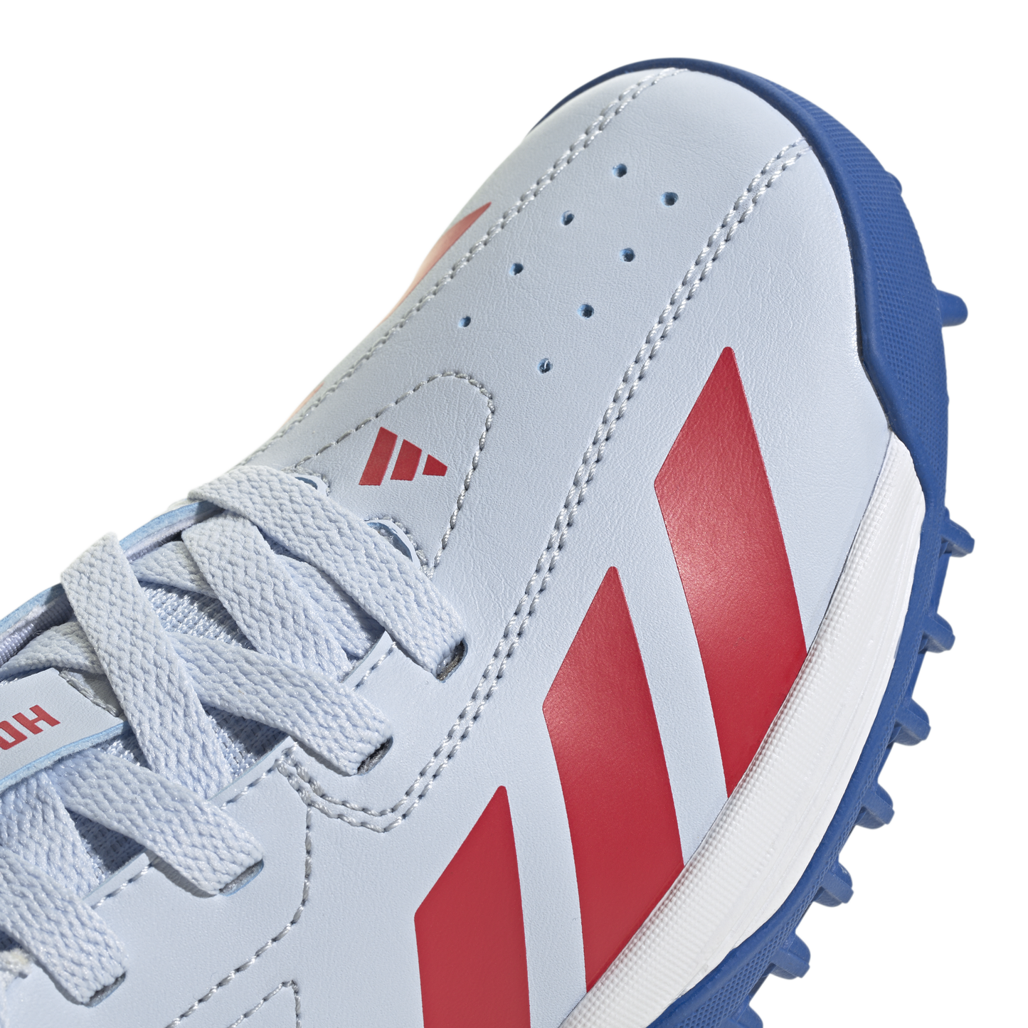 Lace and upper detail of the Adidas Howzat spikeless junior cricket shoe in Crystal Sky.