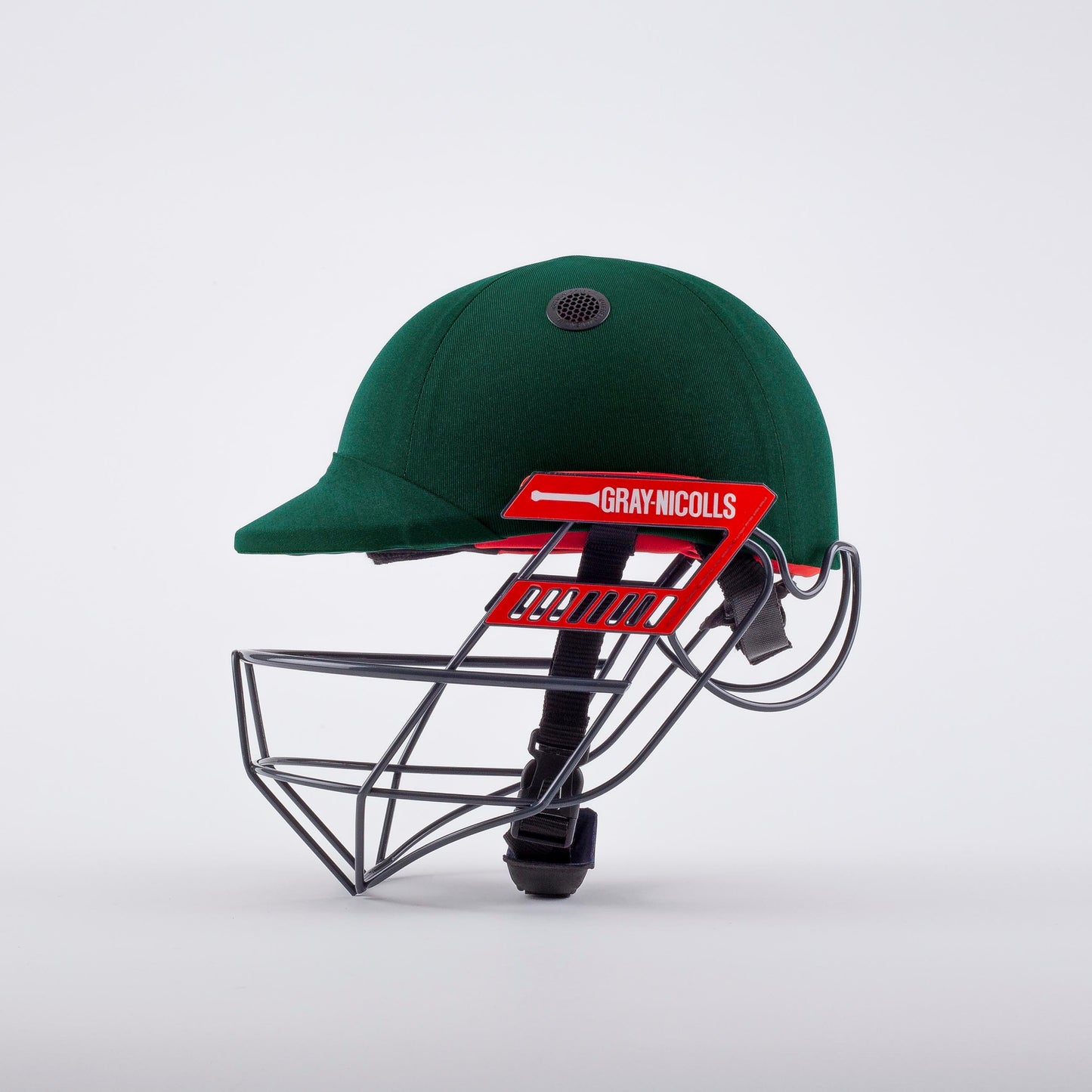 side angle of Atomic 360 Cricket Helmet in green showing grille and branding