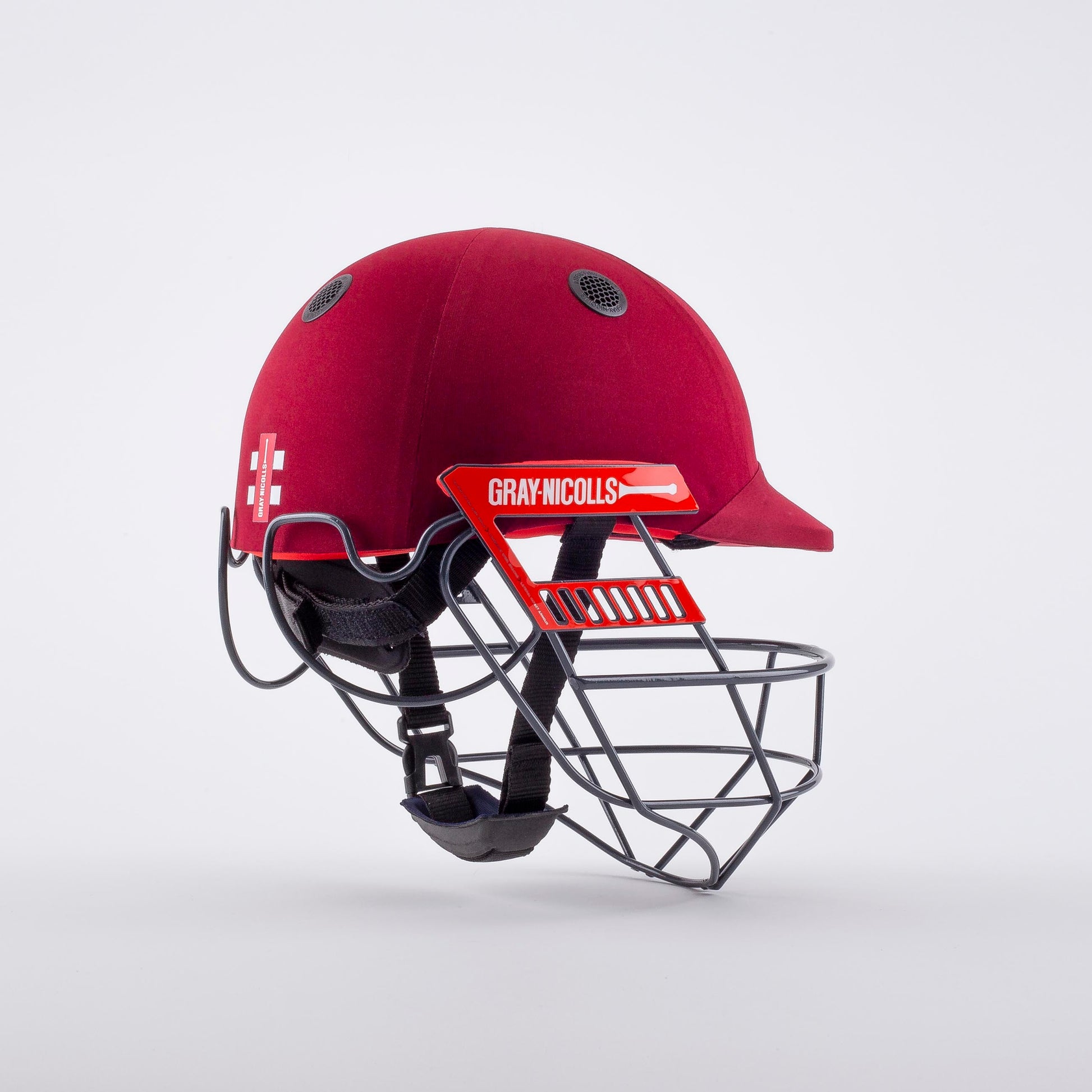 front angled view of Gray-Nicolls Atomic 360 Helmet in red with grille detail
