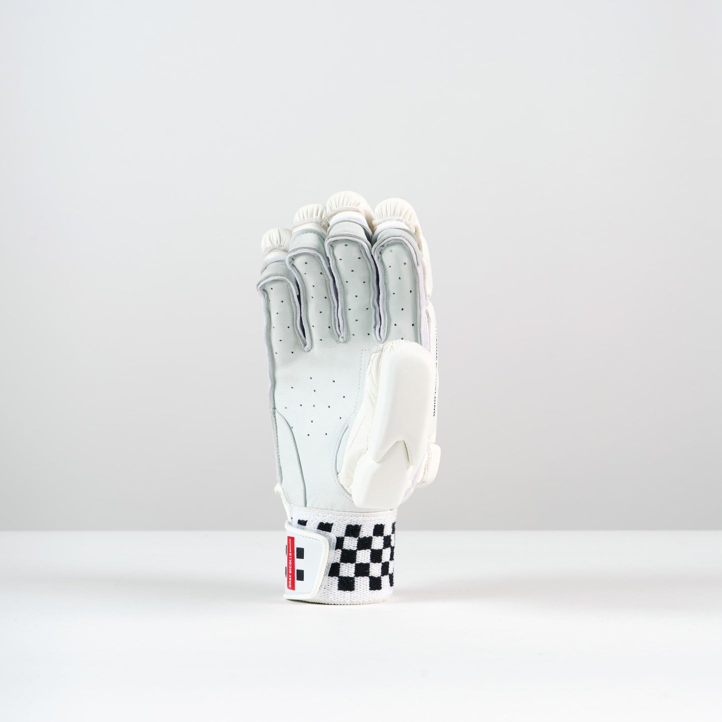 front view of a single Gray-Nicolls Classic Players Batting Glove in white with red logo