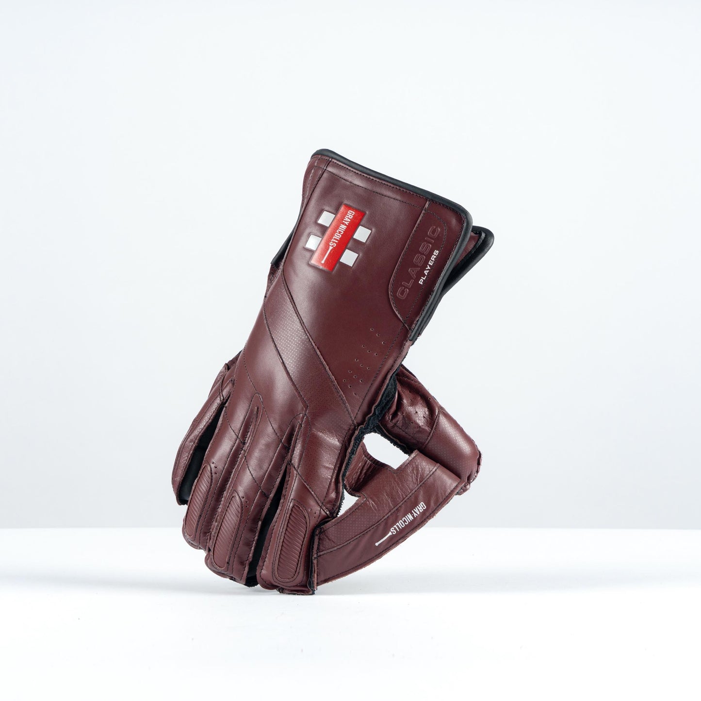 angled side view of Gray-Nicolls Classic Players Edition gloves in brown leather