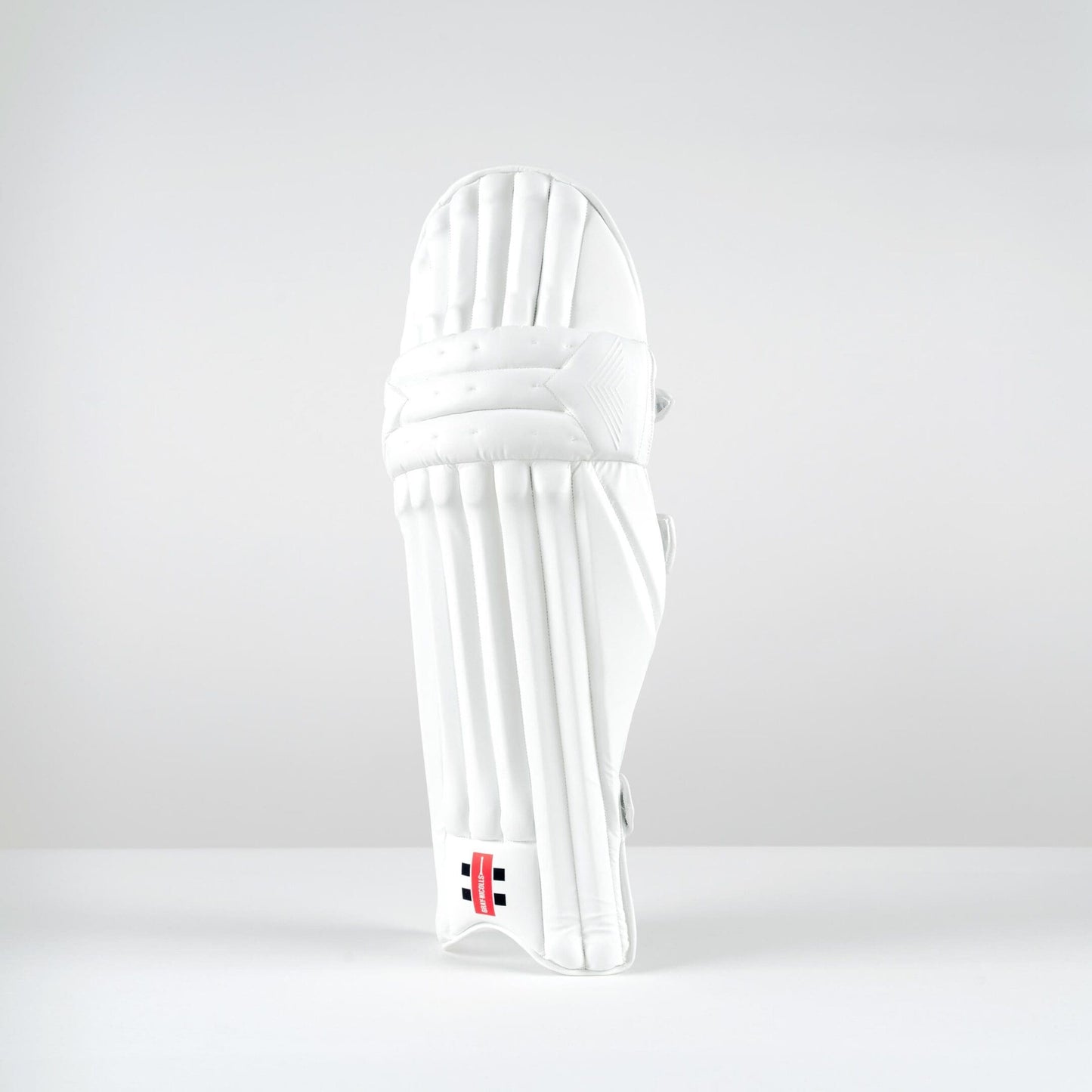 Front view of Gray-Nicolls Classic Prestige batting pads featuring traditional vertical cane styling in all-white finish