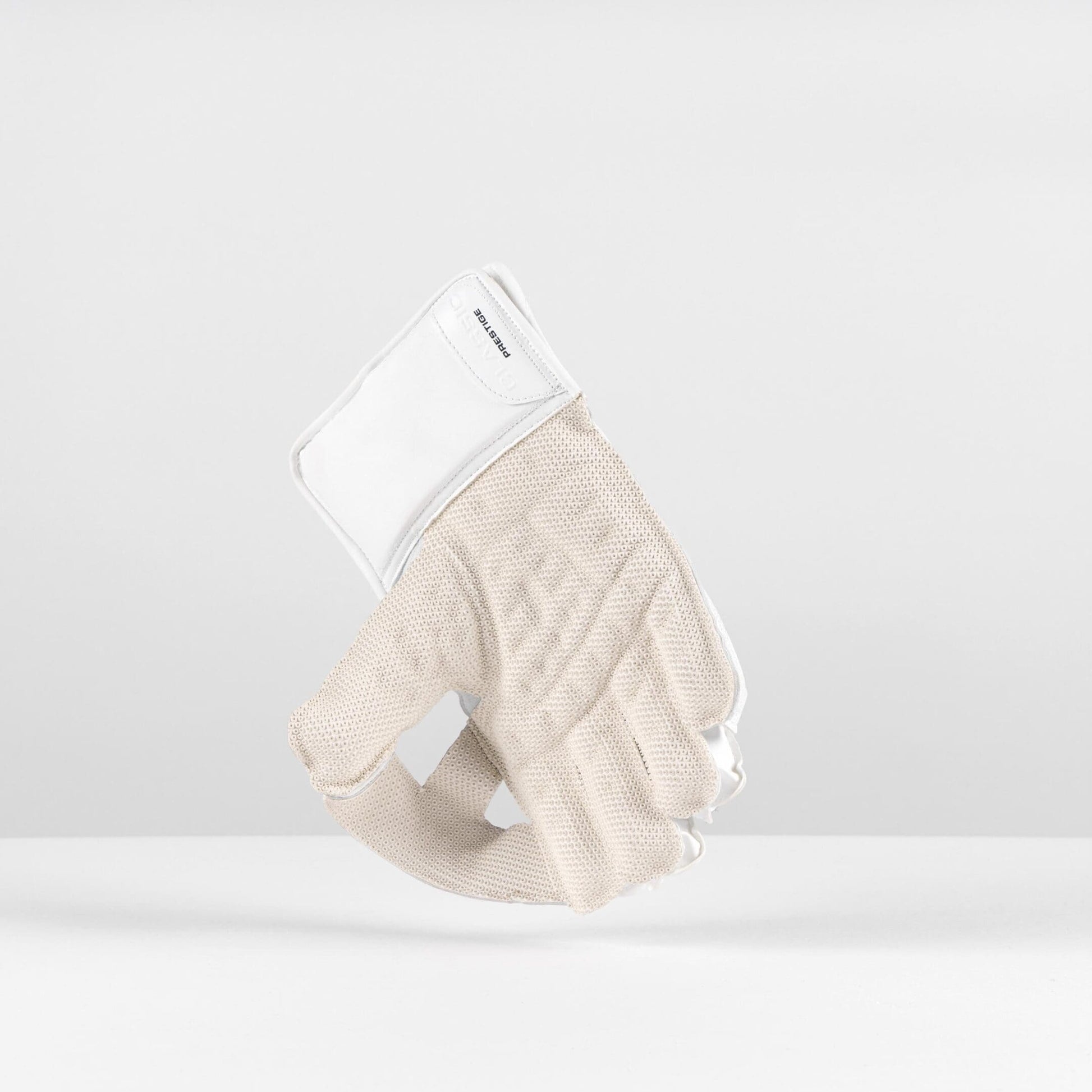 Side view of Gray-Nicolls Classic Prestige wicketkeeping gloves in white highlighting cuff and leather detailing