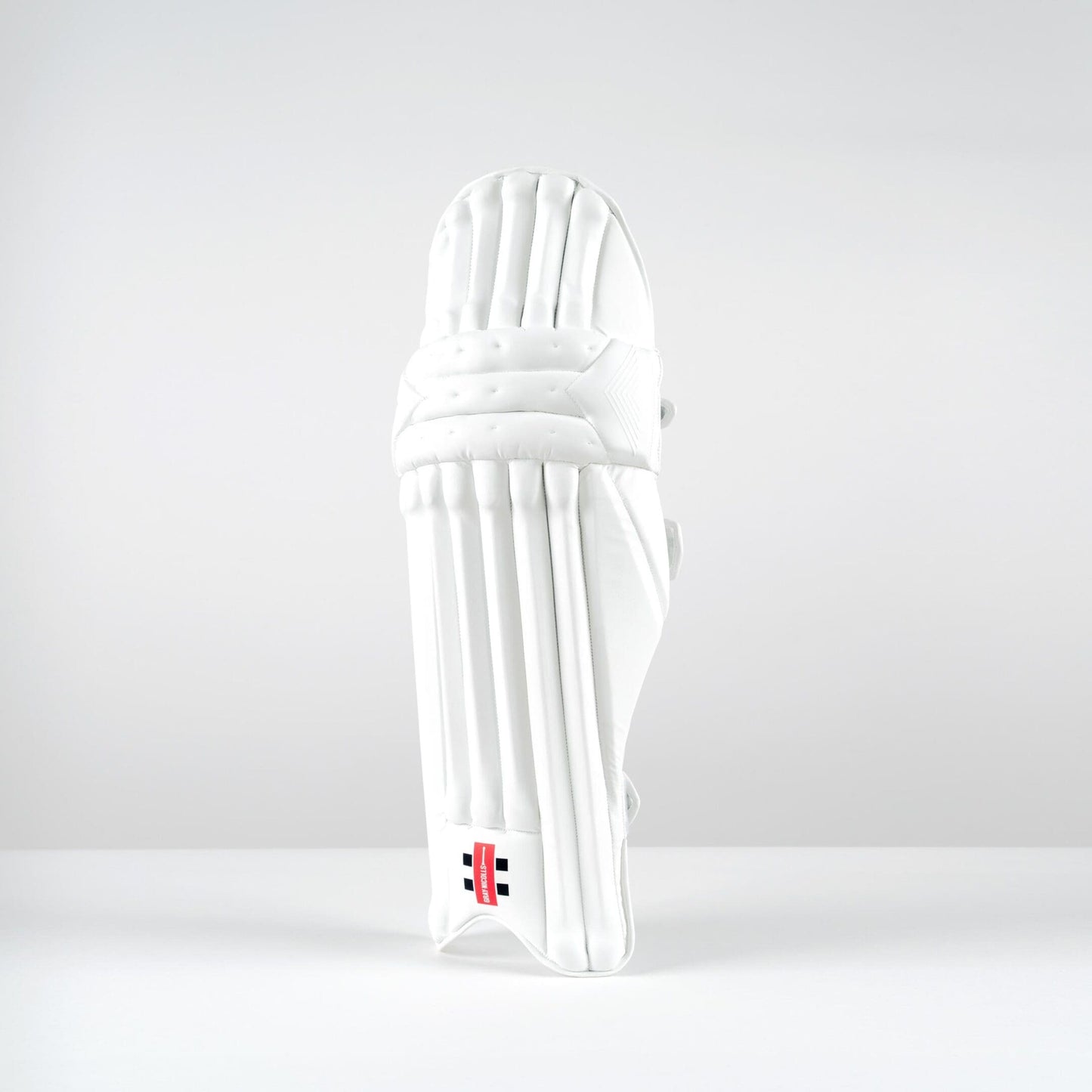 Front view of Gray-Nicolls Classic Pro Performance batting pads with vertical cane construction and sleek white finish