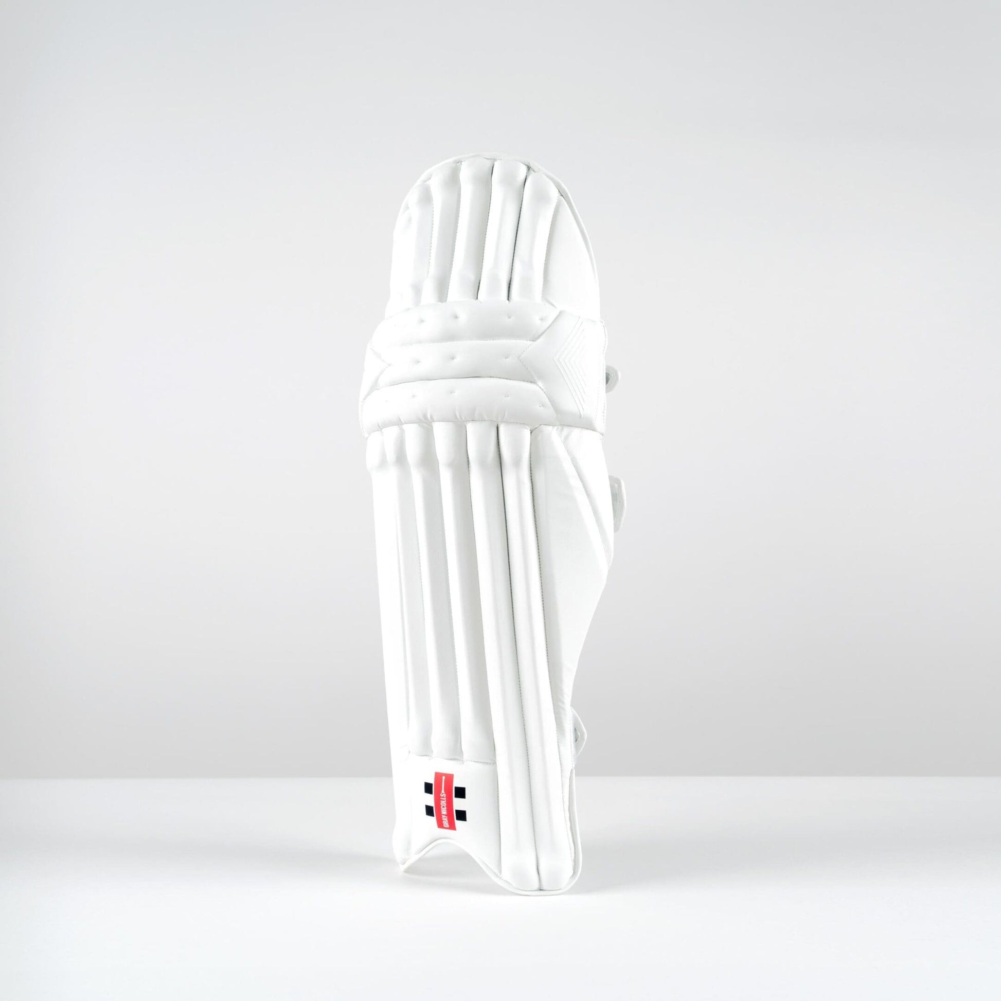 Front view of Gray-Nicolls Classic Pro Performance batting pads with vertical cane construction and sleek white finish