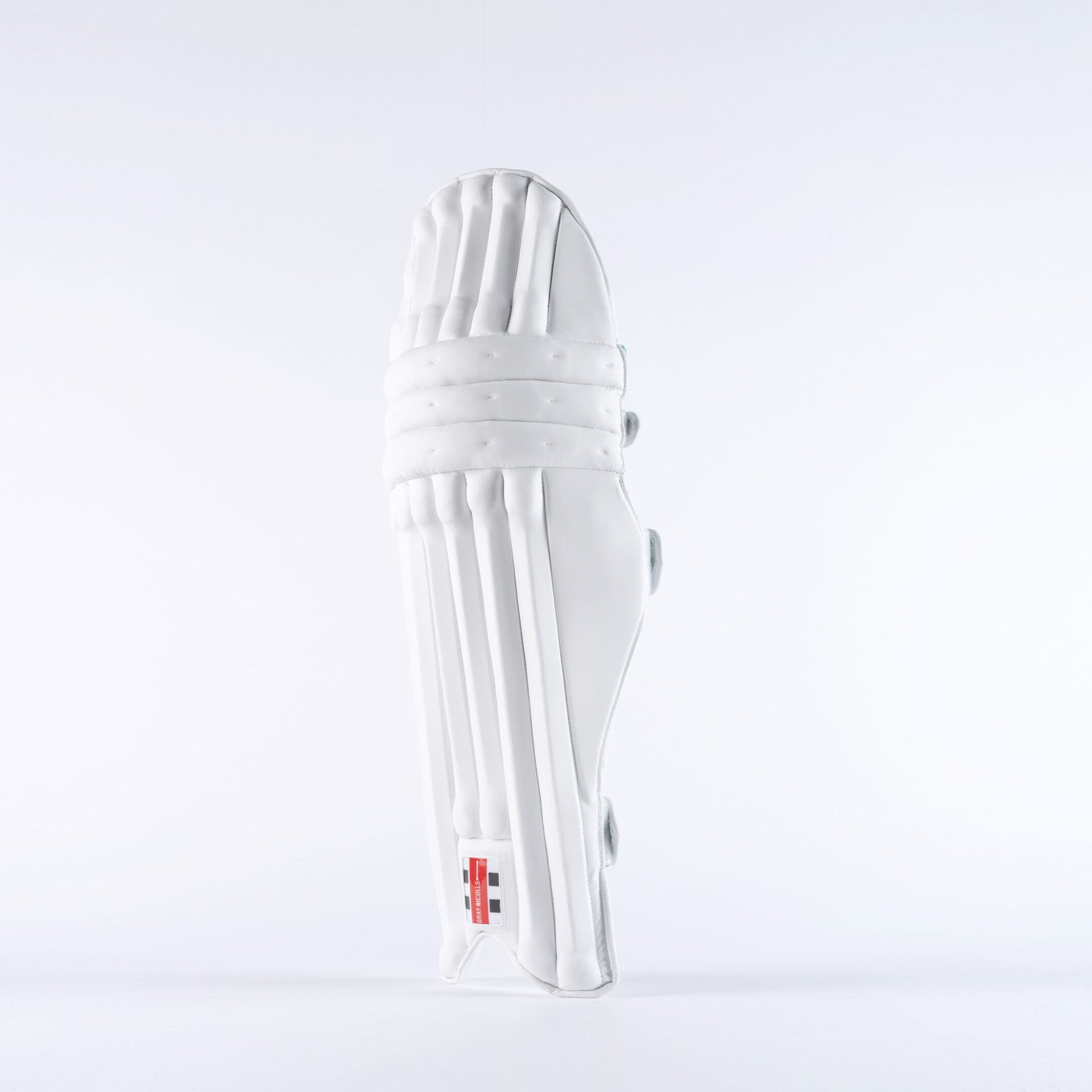 Side profile of Gray-Nicolls Classic Pro Performance pads in white showing curved shape and ankle wing