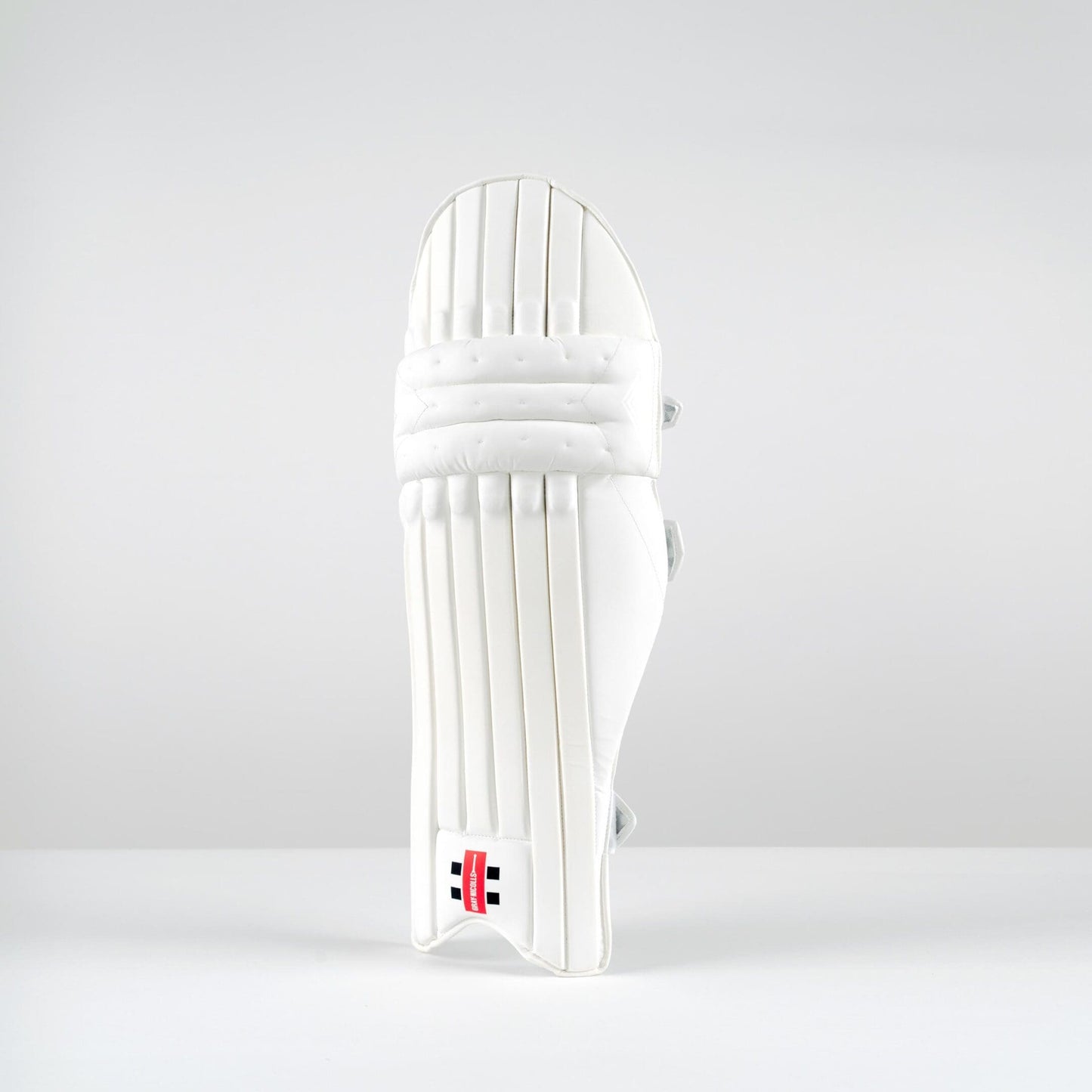 Front view of Gray-Nicolls Classic Select batting pads in all-white finish with vertical cane construction