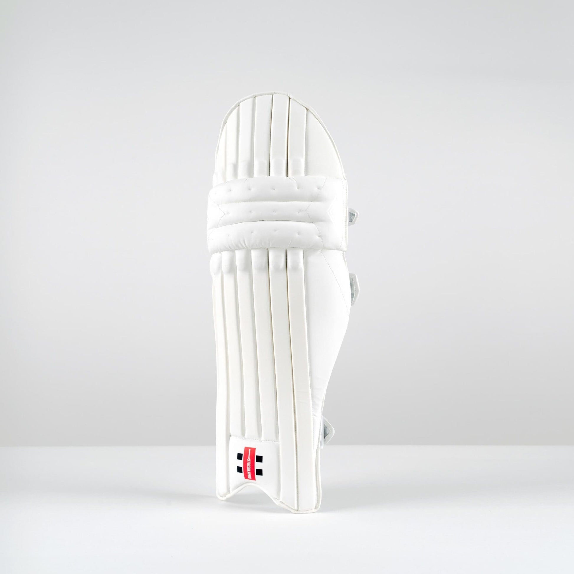 Front view of Gray-Nicolls Classic Select batting pads in all-white finish with vertical cane construction