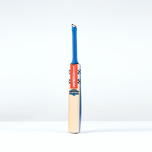 Front Angled view of the Gray Nicolls Havoc 1.0 Smash Junior Cricket Bat with blue grip and natural blade
