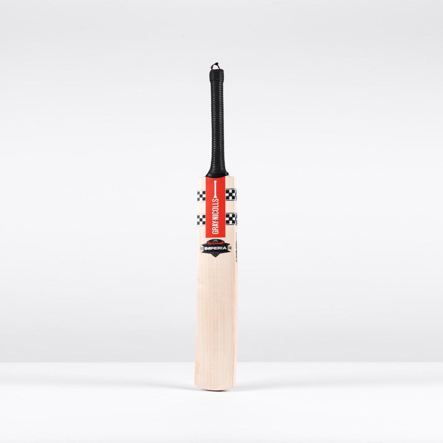 front view of Gray Nicolls Imperia Gen 1.0 Pro cricket bat with red stickers and black grip