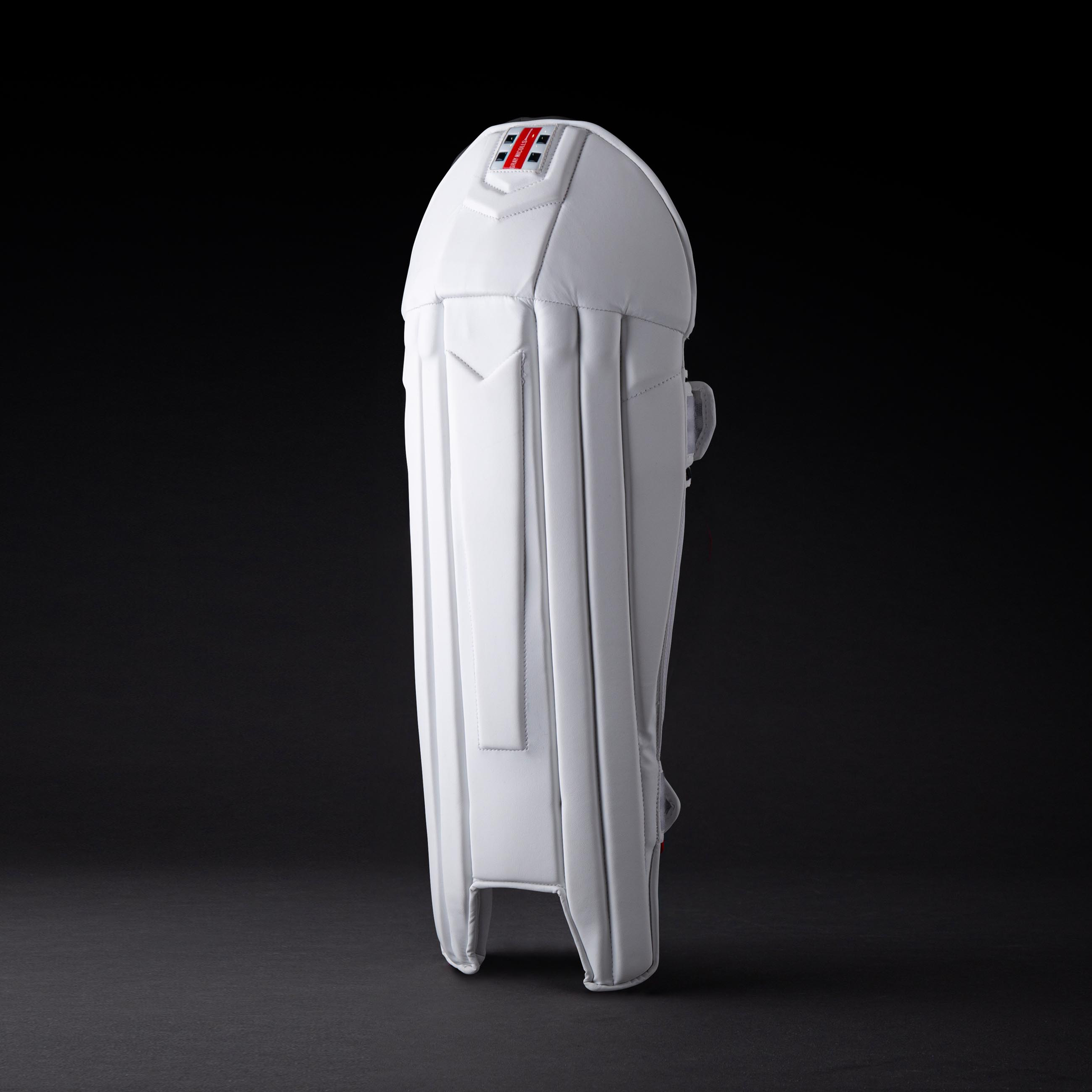 front view of Gray-Nicolls Legend Wicket Keeping Pads on dark background