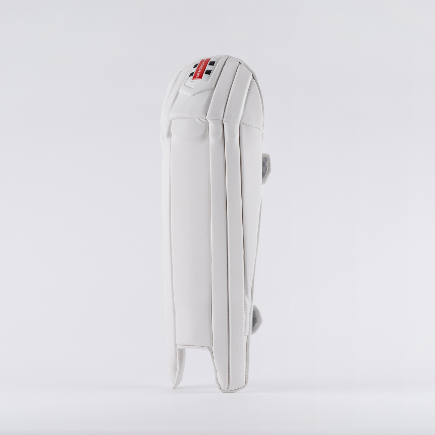 front view of Gray-Nicolls Prestige Wicket Keeping Pads in white with red and black logo