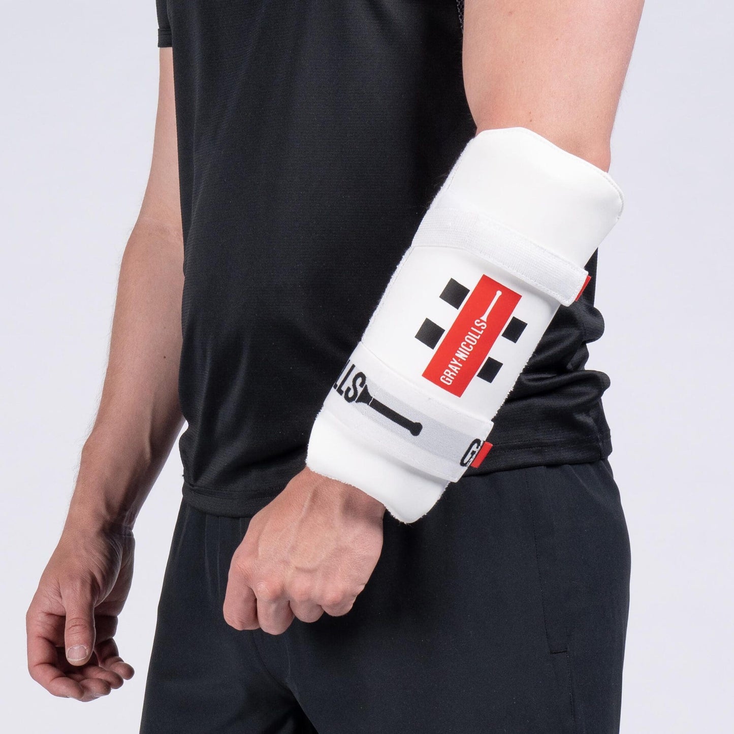 Gray-Nicolls Test Armguard worn on forearm, showcasing ergonomic fit and robust padding