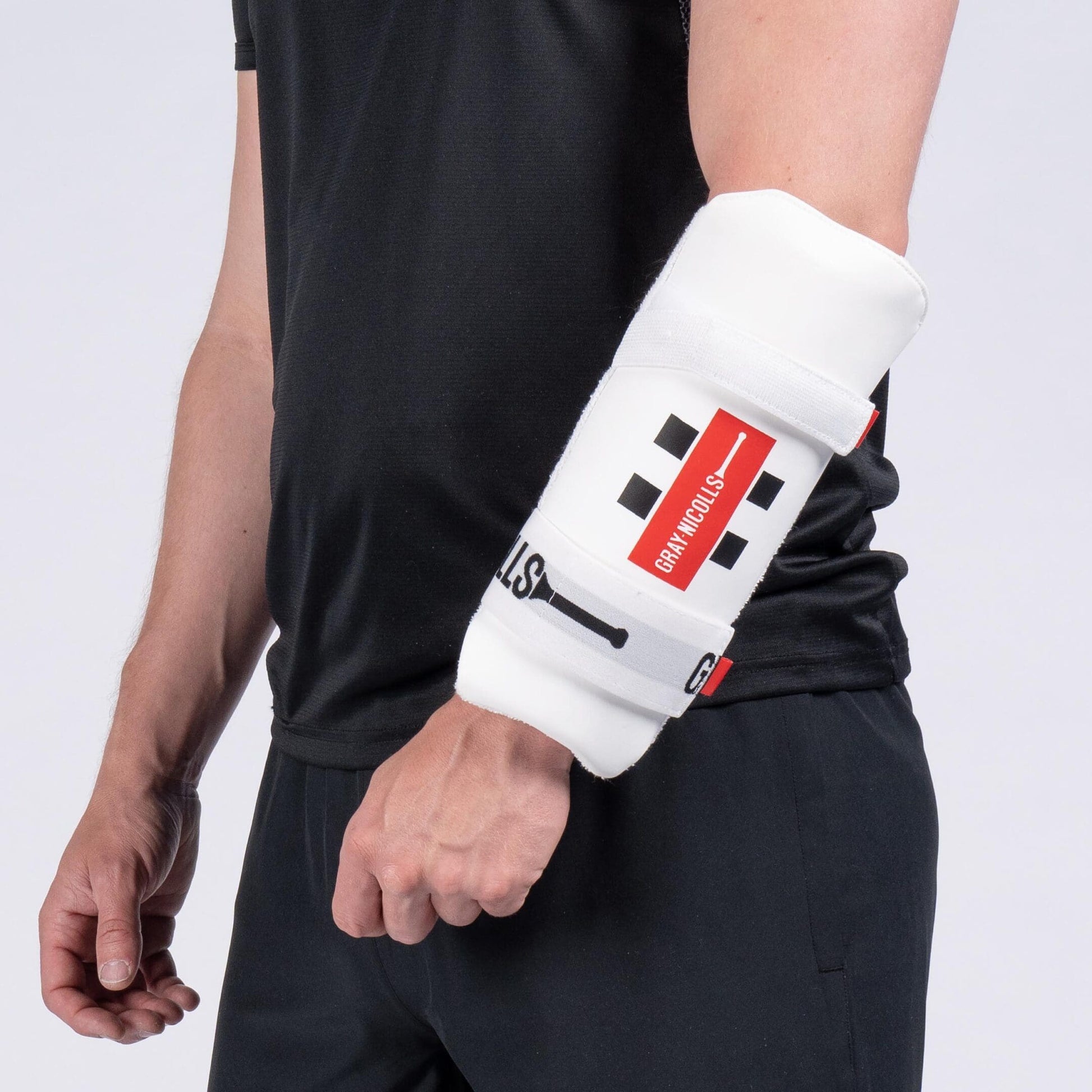 Gray-Nicolls Test Armguard worn on forearm, showcasing ergonomic fit and robust padding