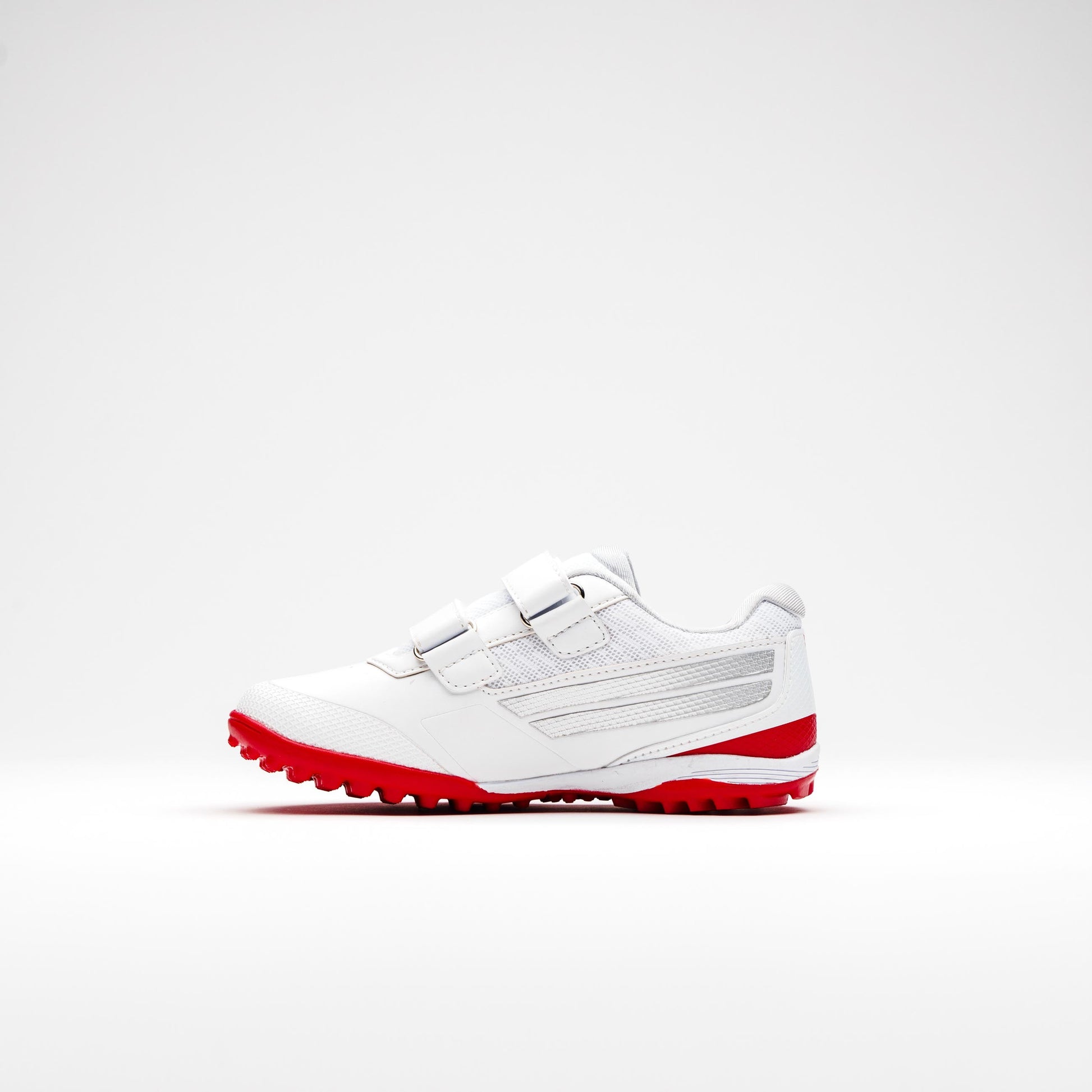 Side profile of kids’ cricket shoes with red sole