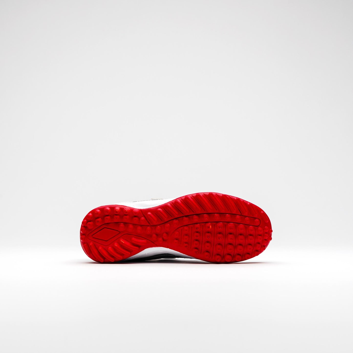 Full view of textured red rubber outsole for cricket shoes