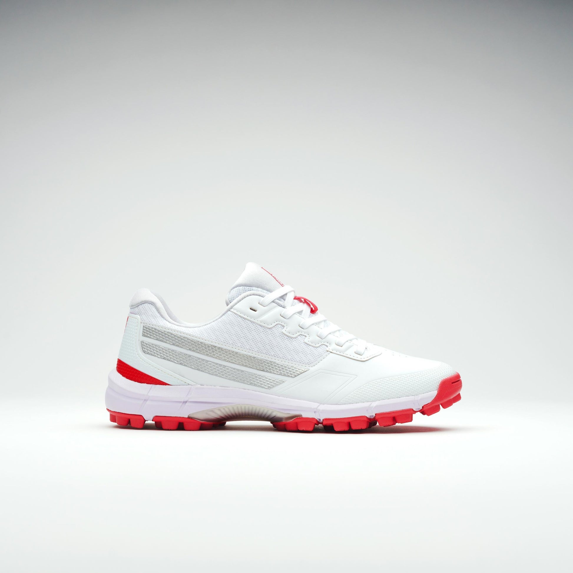 Opposite side view of white cricket shoes with durable outsole