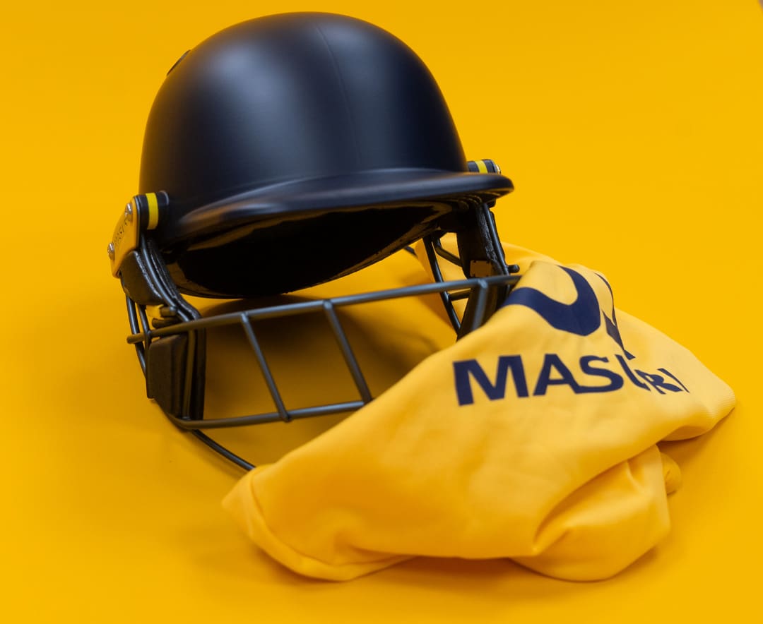 Masuri E-Line Plus Titanium senior helmet with yellow branded bag folded beneath, front angle