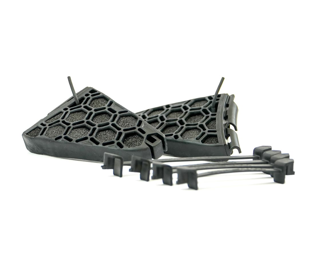 Flat lay of Masuri StemGuard Elite Senior set with hex shell and connectors for helmet attachment