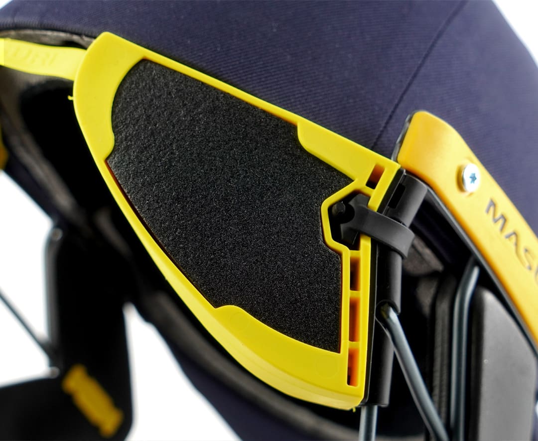 Close-up of Masuri StemGuard Lite Junior attached to helmet from the left side, showing fastening system