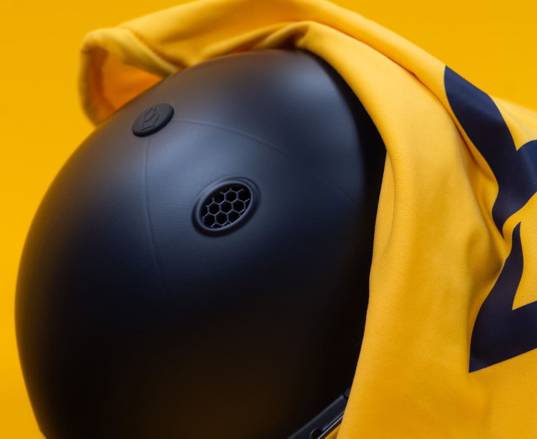 Top rear view of Masuri T-Line Plus Steel senior helmet in navy partially covered with yellow cloth