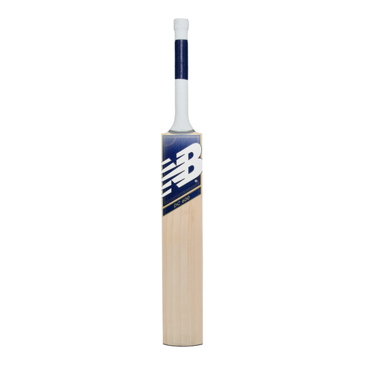 Front view of the New Balance DC 600 cricket bat showing DC branding and blade profile.