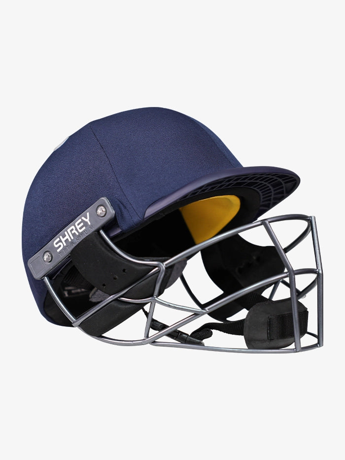 Angled view of Shrey Elite Pro Titanium Fixed Visor Senior Batting Helmet in navy blue showing visor and airflow vents.
