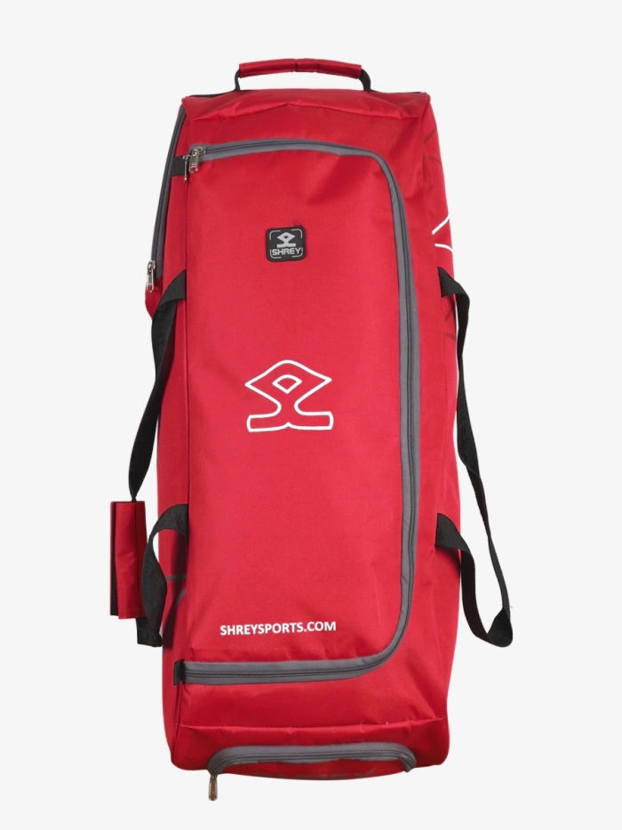Red Shrey Ryder Wheelie bag in upright position with telescopic handle