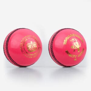Front and back view of the Kookaburra County Match Pink Cricket Ball, featuring the gold crown emblem on one side and the Kookaburra bird logo on the other.