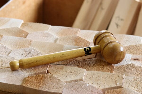 Front and side veiw of the GM bat mallet pictured on top of a honeycomb wood board