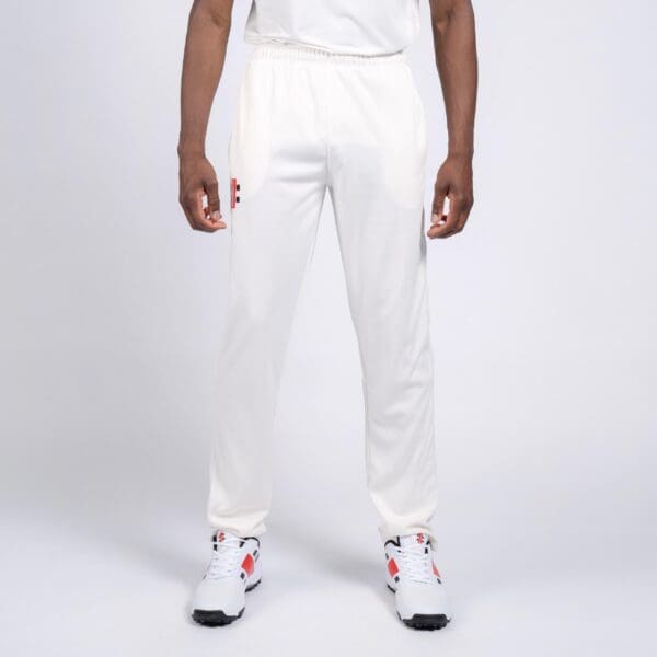 Front-on view of Gray-Nicolls cricket trousers with hands by side