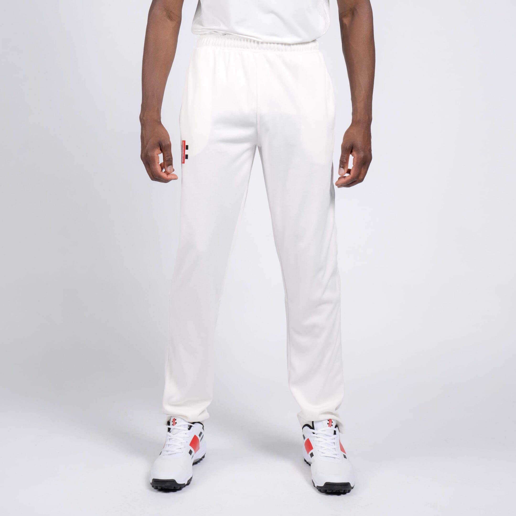 Front-on view of Gray-Nicolls cricket trousers with hands by side