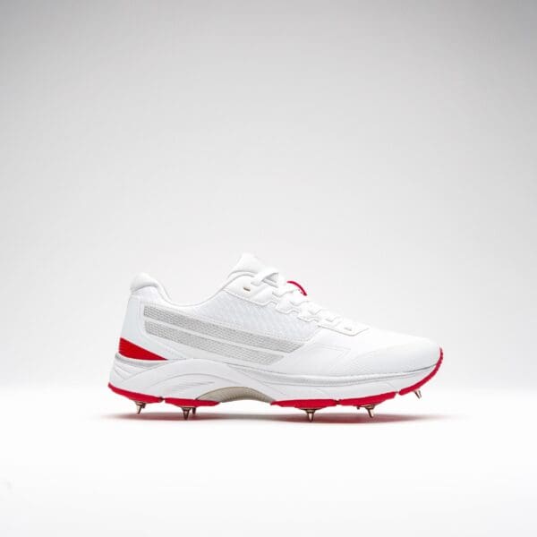 Side view of right Gray-Nicolls Velocity 5.0 Junior Spike Shoe with red outsole